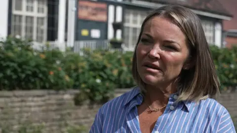 Image of Julie Collins speaking in front of cafe