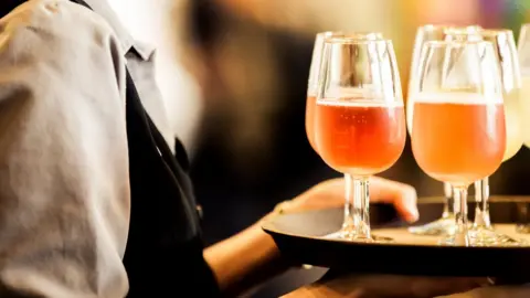 Getty Images Waitress with drinks