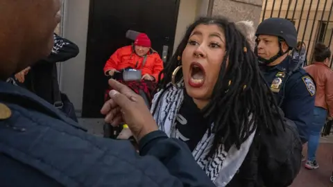 Protester shouts at police officer after being arrested