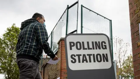 Getty Images Man arriving at a polling station
