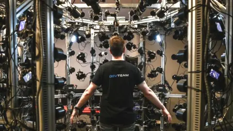 Getty Images An employee stands in a cage during the presentation of a photogrammetry process at the French video games firm Quantic Dream