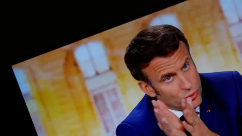 Reuters Emmanuel Macron gestures in this still image of a television displaying the debate feed