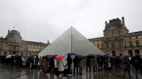 Reuters People queue up outside the Louvre on 1 March