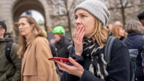 Getty Images People react as the Stock Exchange building burns in central Copenhagen, Denmark on April 16, 2024