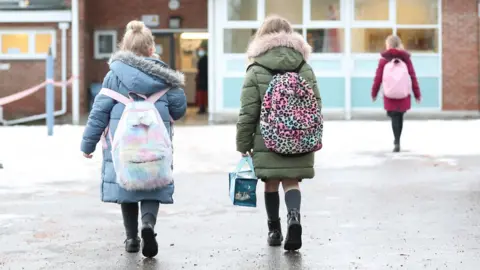 PA Media Girls walking towards a school