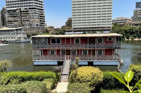 Wael Hussein/BBC Ekhlas Helmy's houseboat on the River Nile in central Cairo, Egypt