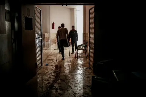Getty Images Syrians inspect damage inside a hospital in Atarib district in Idlib de-escalation zone, western Aleppo, Syria on 22 March 22 2021