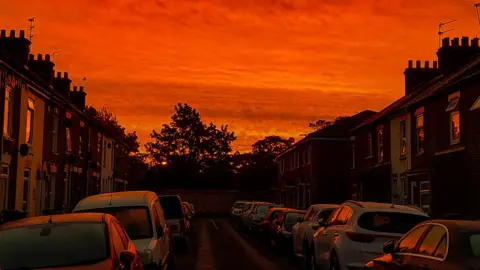 Weather watchers/Simon Luckman 1988 Red skies at sunrise in Great Yarmouth, Norfolk.