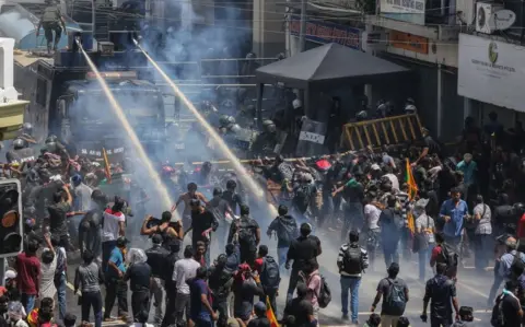 EPA Security forces' water cannon hitting demonstrators in Colombo, 9 Jul 22