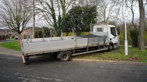 PA Media Flatbed lorry outside the gates in Marston Mortaine