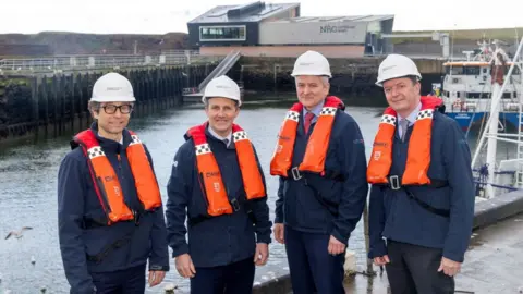 Matthieu Hue, CEO of EDF Renewables UK; Michael Matheson MSP; Matthias Haag, NnG Project Director and John O’Connor, Generation Delivery at ESB at the new building in Eyemouth.