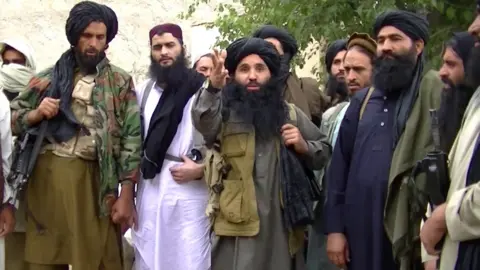 EPA A grab taken from an undated handout video released by the Tehrik-e-Taliban Pakistan (TTP) shows its head Mullah Fazlullah (centre) at an undisclosed location at Pak-Afghan border (file photo)