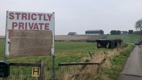 A sign by a road asking people to stop donating.