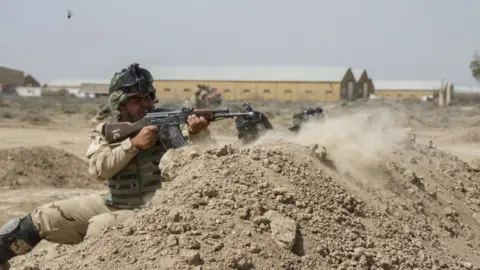 Reuters Iraqi troops train with US soldiers at the Taji base. File image