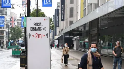 PA Media Social distancing sign in London's Oxford Street