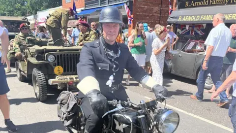 Woodhall Spa 1940s Festival 2022 Man dressed in period 1940s policing outfit on a vintage bike