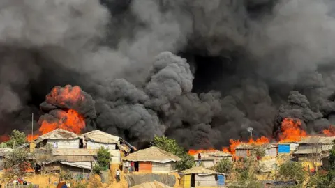 Fire burns in the Rohingya refugee camp in Balukhali in Cox's Bazar, Bangladesh