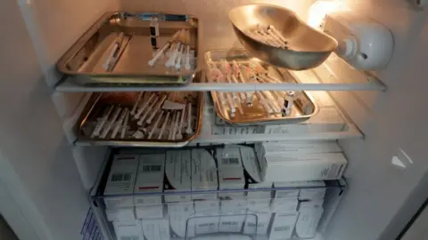 Reuters Syringes with doses of the Pfizer Covid-19 vaccine are seen in a fridge