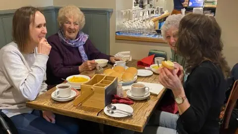 The Rising Sun Pub Four women enjoying a cup of tea and chatting at The Rising Sun