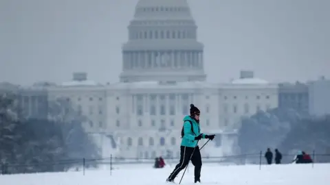 AFP A cross country skier passes the US Capitol during a winter storm January 13, 2019 in Washington