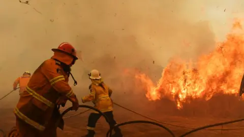 Getty Images RFS Firefighters battle a spot fire on November 13, 2019 in Hillville, Australia.