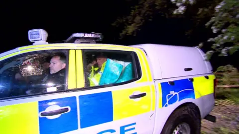 Police car carrying suspect Joseph McCann