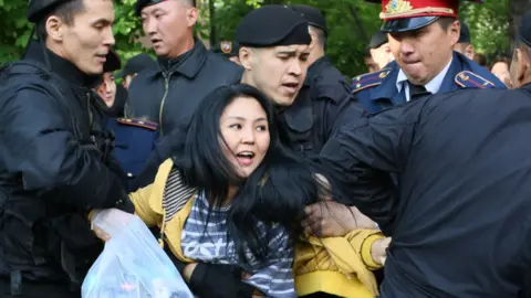 Ruslan Pryanikov/AFP/Getty Images Protester detained on May Day in Almaty, Kazakhstan, 2019