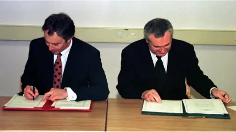 PA/Dan Chung File photo dated 10/04/98 of then prime minister Tony Blair (left) and then Taoiseach Bertie Ahern signing the Good Friday peace agreement