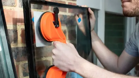 Getty Images Double glazing being installed