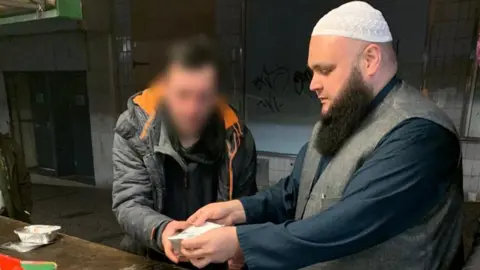 As-Salaam Man receiving meal