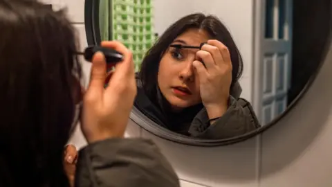 POLLY BRADEN Sofiia putting make up on after school in Katowice in April 2022