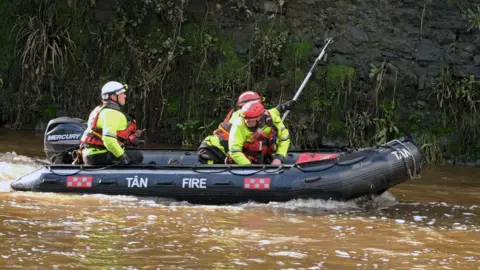 Martin Cavaney/Athena Pictures Crew in a boat on the River Cleddau