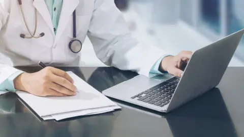 Getty Images Doctor with a computer