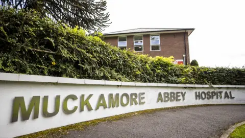 PA Media Muckamore Abbey Hospital sign.