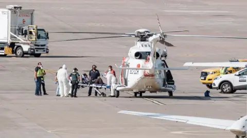 EPA A woman is evacuated in helicopter after being rescued in Telde, Gran Canaria, Canary Islands, Spain, 19 August 2021