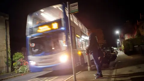 Peter Byrne Passenger waiting for the number 16 bus in the early morning