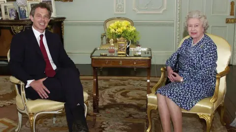 PA Media Tony Blair sits alongside Queen Elizabeth II in Buckingham Palace