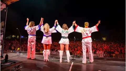 Camp Bestival The four members of Bjorn Again waving to the crowd