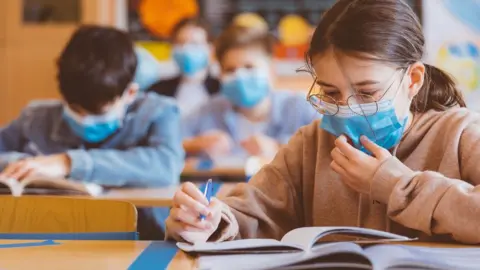 Getty Images Students wearing face masks