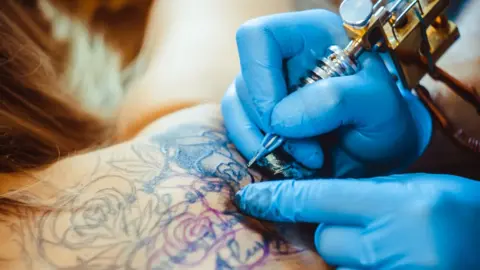 Getty Images Tattoo artist at work