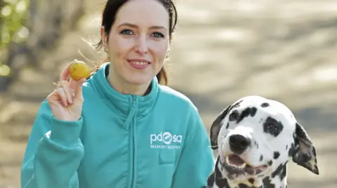 PA Vet Gemma Hepner with Pongo and the golf ball that was removed from his stomach