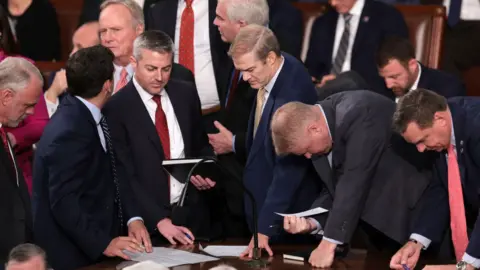 Getty Images Jim Jordan talks with staff and fellow lawmakers as the House of Representatives meets to elect a new Speaker of the House