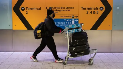 Getty Images Woman wearing face mask in an airport