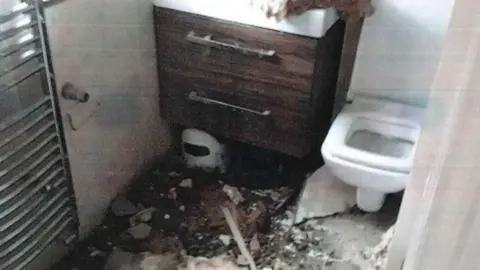 Richmond Council Bathroom with debris from collapsed ceiling