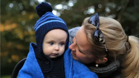 Alexandra Vanotti smiling at her child