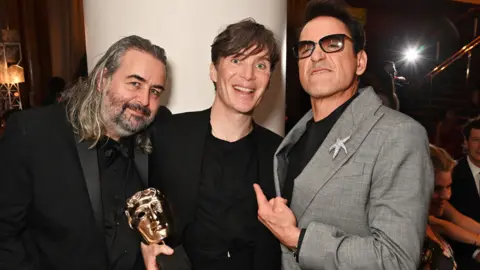 Getty Images Hoyte van Hoytema, Cillian Murphy and Robert Downey Jr after the Baftas