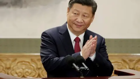 Reuters China's President Xi Jinping claps