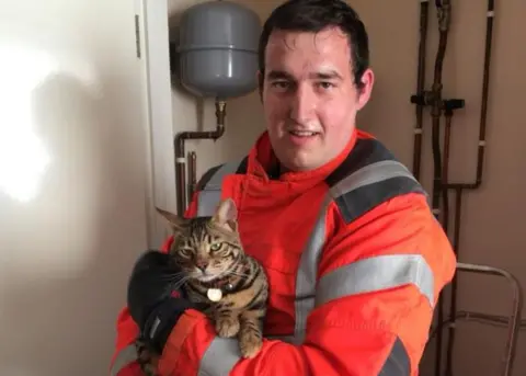 Cambs Fire and Rescue Felix the cat with rescuer