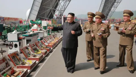 KCNA Kim Jong-un inspects goods at an exhibition in Pyongyang
