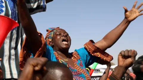 Reuters A woman reacts as people gather in support of a coup that ousted President Roch Kabore, dissolved government, suspended the constitution and closed borders in Burkina Faso, Ouagadougou January 25, 2022.